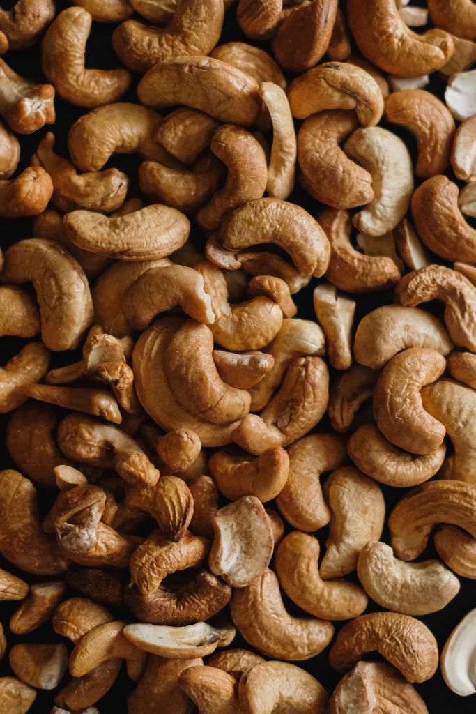 High-quality close-up of roasted cashew nuts, perfect for food photography and culinary designs.